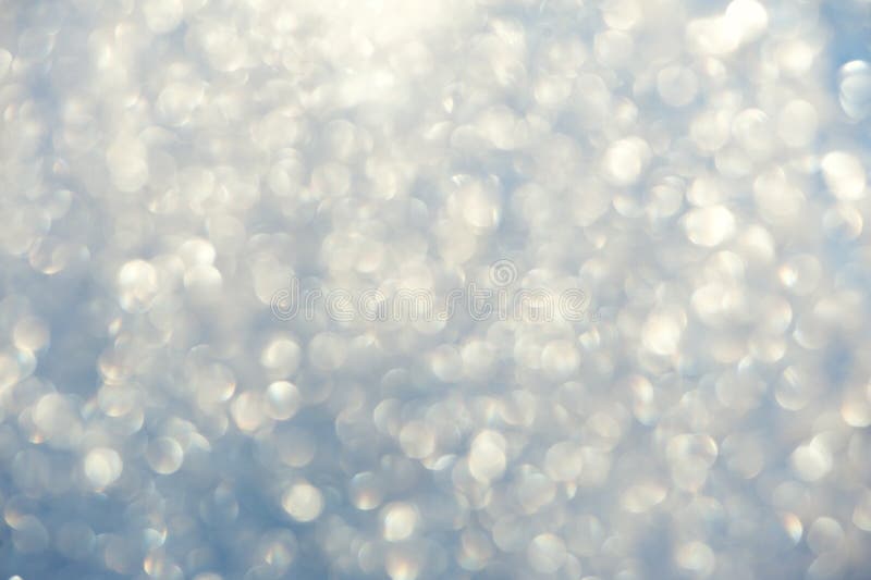 Frosty bokeh glitter sparkle abstract background with defocused lights