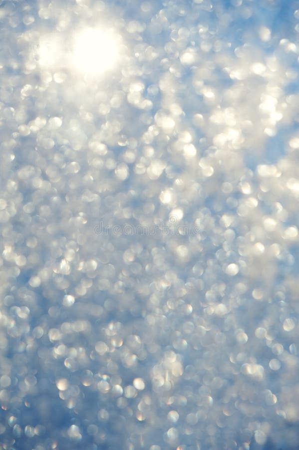 Frosty bokeh glitter sparkle abstract background with defocused lights