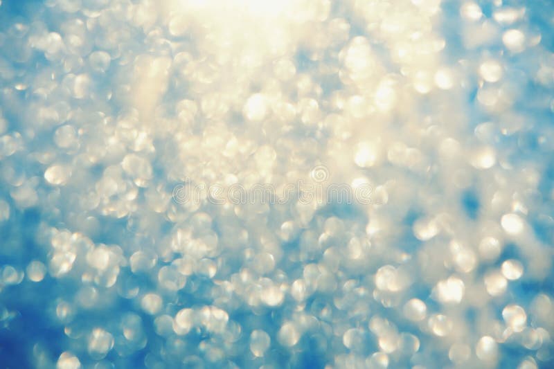 Frosty bokeh glitter sparkle abstract background with defocused lights