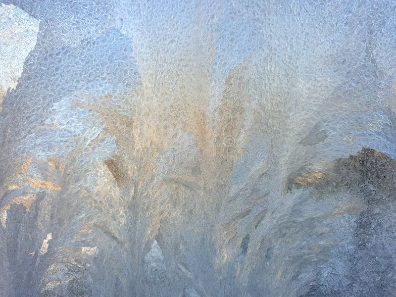 Frosty patterns on the window glass closeup. natural textures and backgrounds. ice patterns on frozen