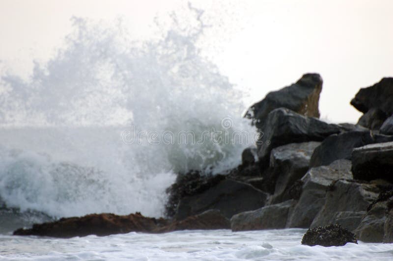 The spray appeared to be frozen in mid air as it crashed up against these rocks at New Port Beach, CA.
