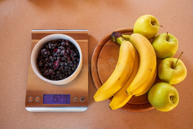 Two apples on a digital kitchen scale - Stock Image - H305/0140 - Science  Photo Library