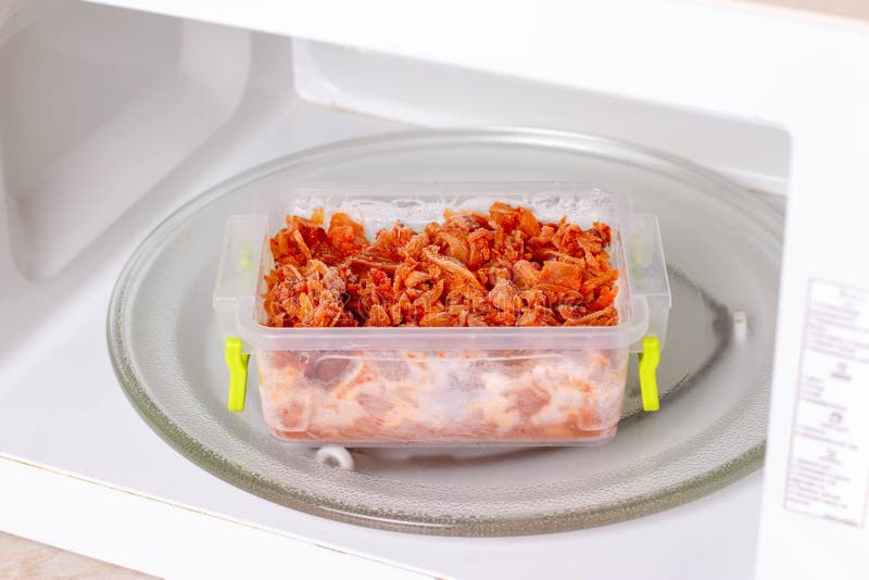 Frozen Braised Cabbage in a Container in the Microwave. Frozen Food