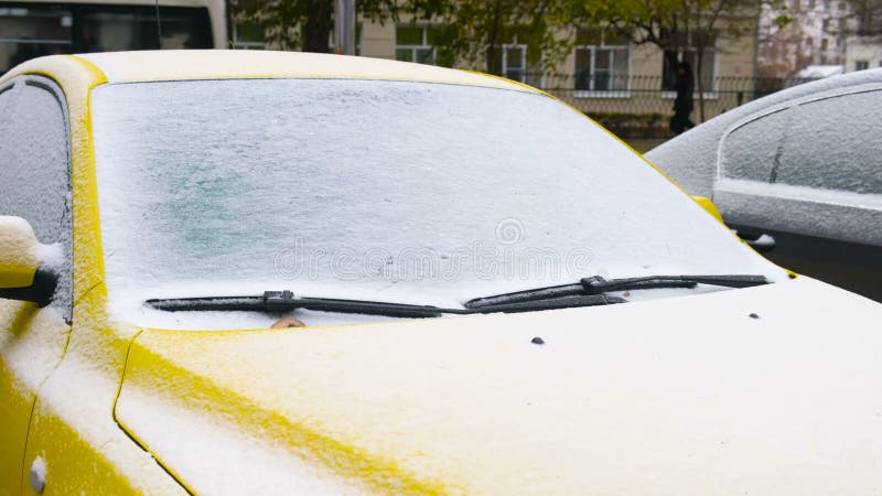 Frozen car covered snow at winter day, view front window windshield and hood. stock video
