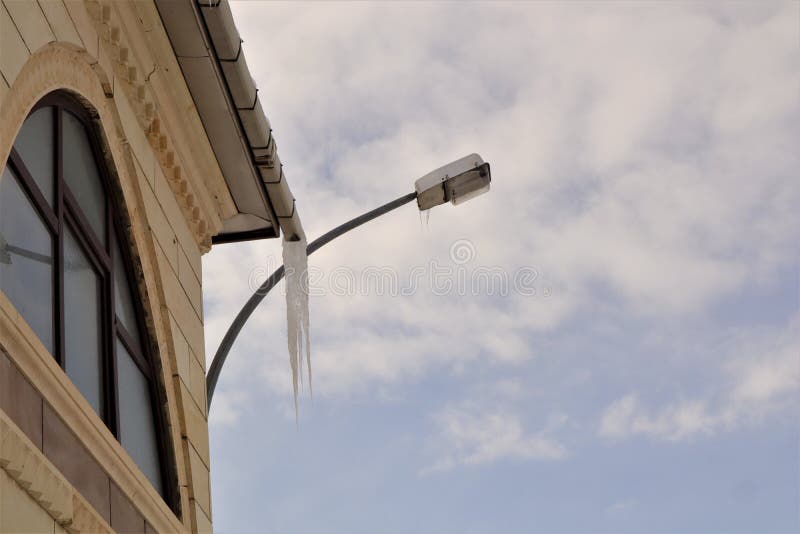 Frozen Downspout. Common Issue Your Gutter May Encounter during Winter