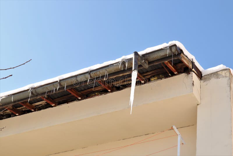 Frozen Downspout. Common Issue Your Gutter May Encounter during Winter