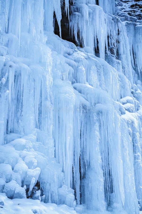 Frozen Icicles on Rocky Wall at the Mountain, Closeup with Selective
