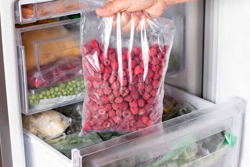 Frozen raspberries in the freezer. Frozen berries