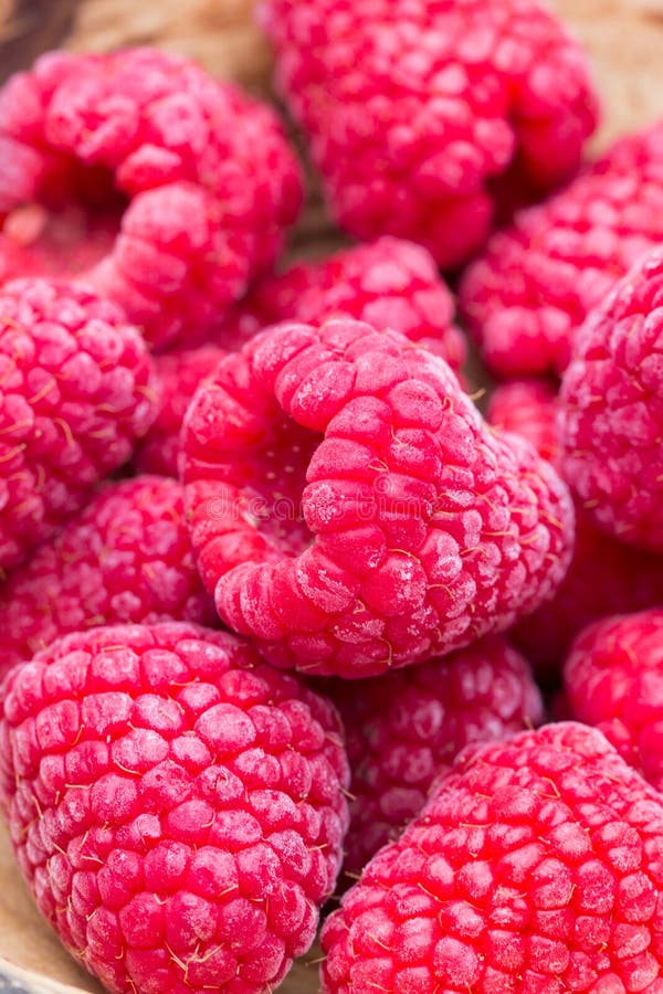 Frozen raspberries on wooden background stock image Frozen raspberries on wooden background stock image