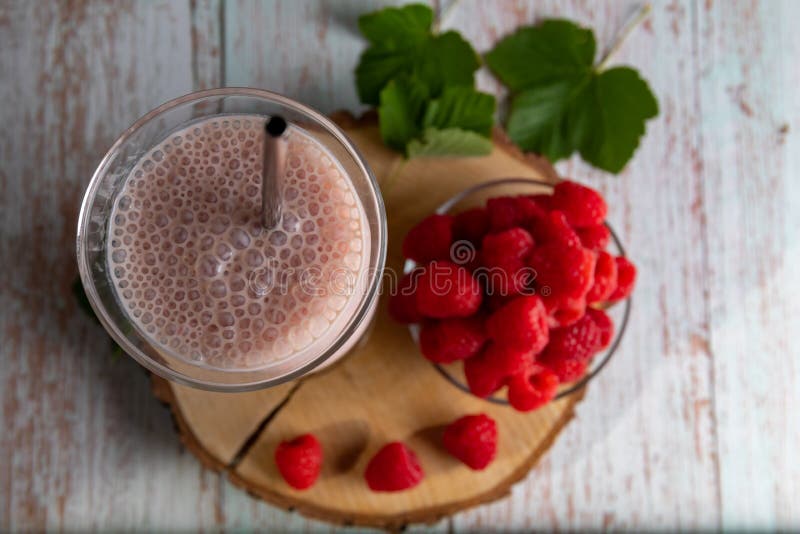 Frozen Raspberry Cocktail with Yogurt on a Birch Wood Slice. Stock