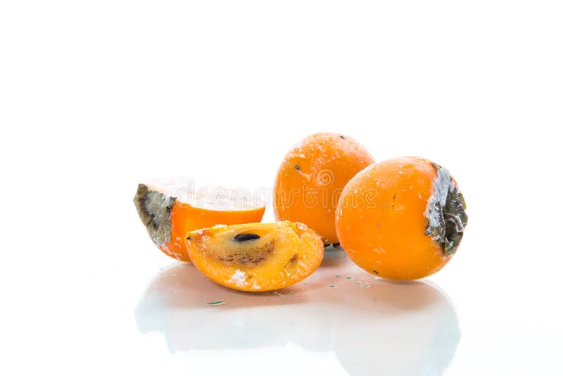 Frozen ripe persimmon in ice isolated on white stock photo Frozen ripe persimmon in ice isolated on white stock photo