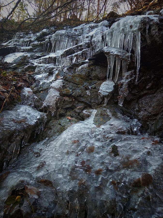 Frozen rock. Icicles on the rock. royalty free stock photos