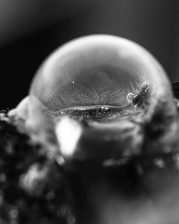 Frozen soap bubble with beautiful light and color on a wooden structure for backgrounds. Soap snowflake stock images, royalty-free photos and pictures