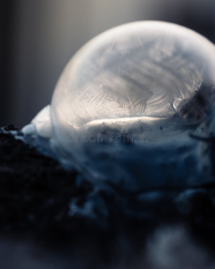 Frozen soap bubble with beautiful light and color on a wooden structure for backgrounds. Soap snowflake stock images, royalty-free photos and pictures