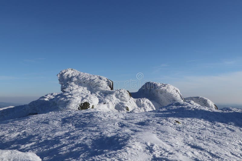 Frozen stones in the middle of nowhere with wonderful and clear sky. Top of the highest mountain in Low Tatras Dumbier. View on