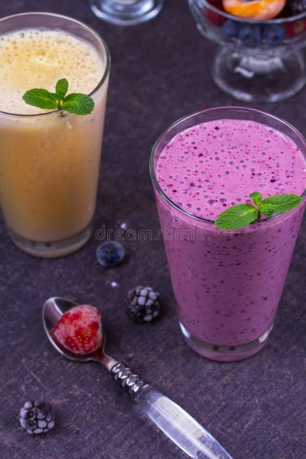 Frozen Summer Berries and Banana Milkshake Garnished with Mint. Stock
