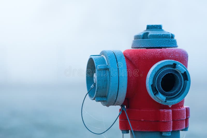 Frozen water hydrant in foggy winter morning royalty free stock photography
