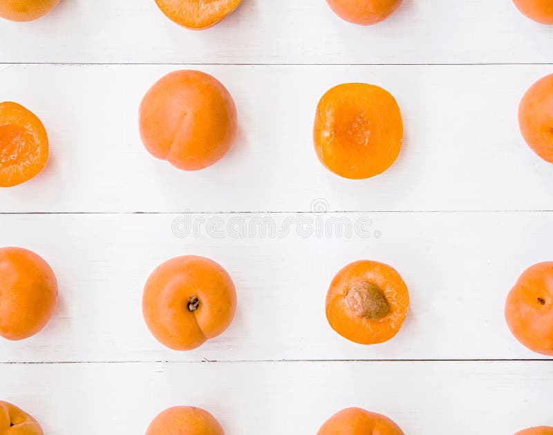 Fresh apricot creative pattern in square on white wooden background with leaves flat lay top view royalty free stock image