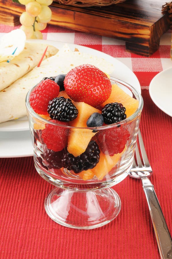 Fruit and berries with breakfast burritos