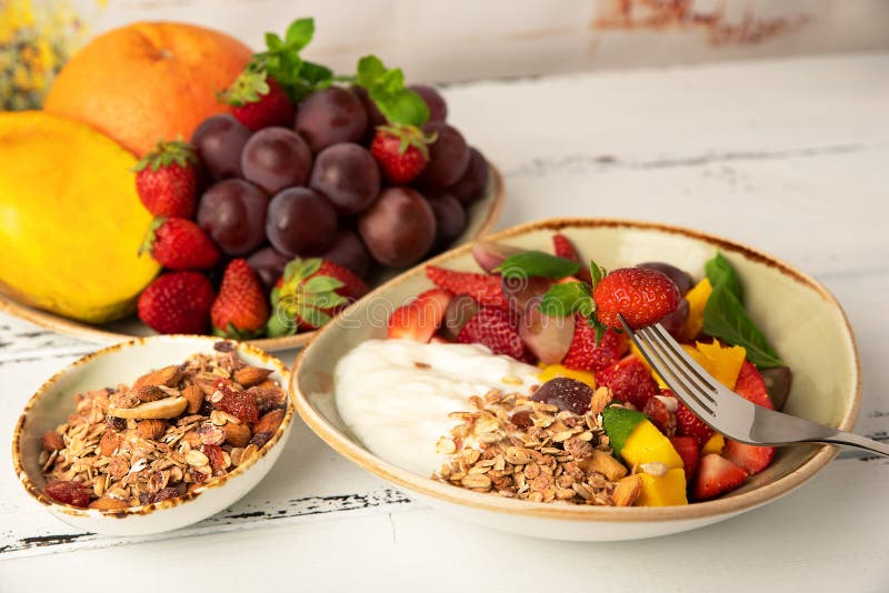 Fruit berry salad with yogurt and granola for healthy breakfast stock images Fruit berry salad with yogurt and granola for healthy breakfast stock images