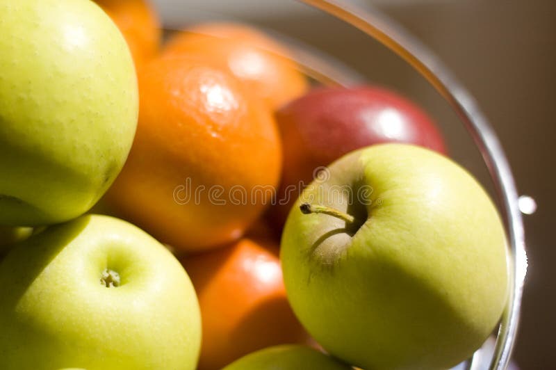 Fruit bowl full of fresh apples and oranges