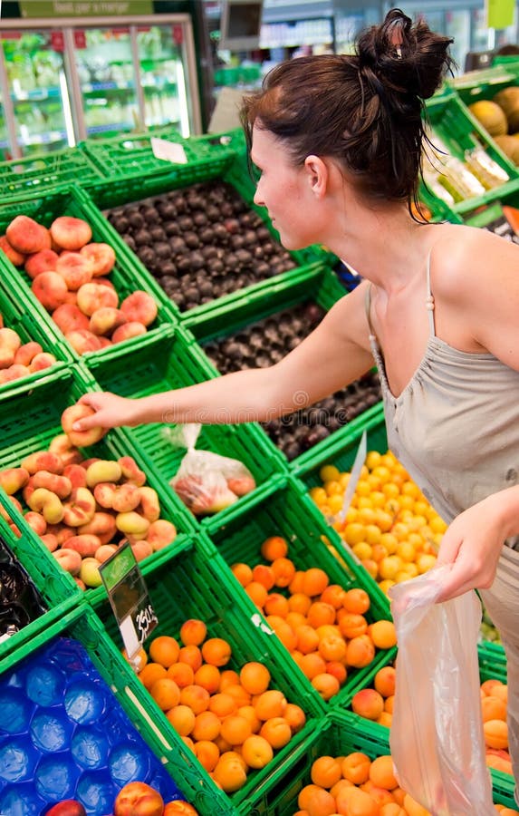Healthy fruits food buying woman with peaches in supermarket. Fruit scene stock images, royalty-free photos and pictures