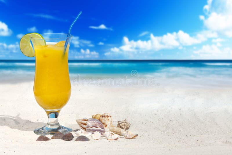 Fruit Cocktail with Orange and Drinking Straw on the Beach with some Seashells and much Copy Space. Fruit scene stock images, royalty-free photos and pictures
