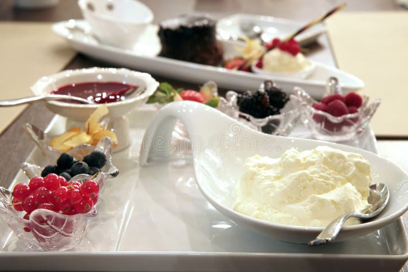 Fruit platter with assortment of berries, strawberry jam and whipped cream. Dessert portions stock images, royalty-free photos and pictures