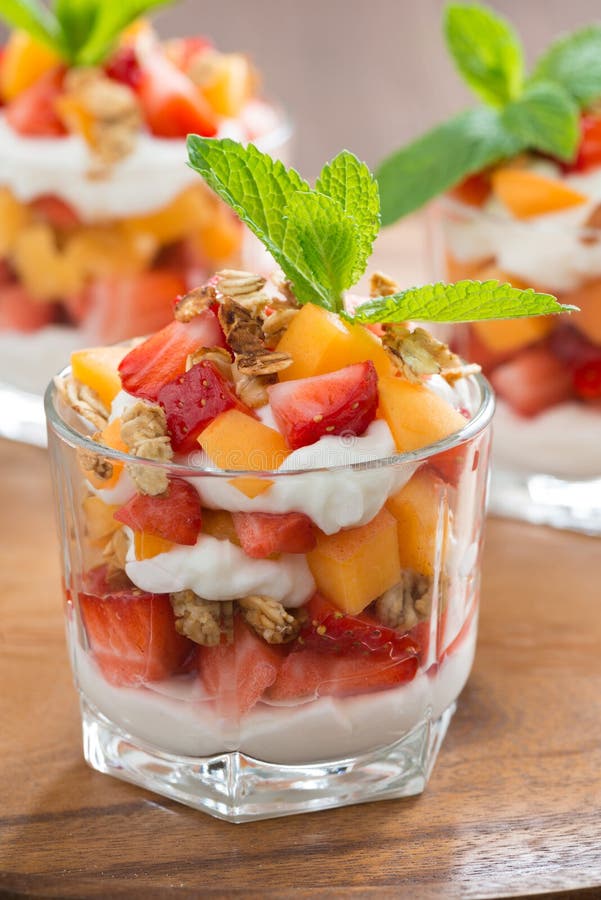 Closeup of Layered Dessert with Yogurt, Granola and Cherry Stock Photo