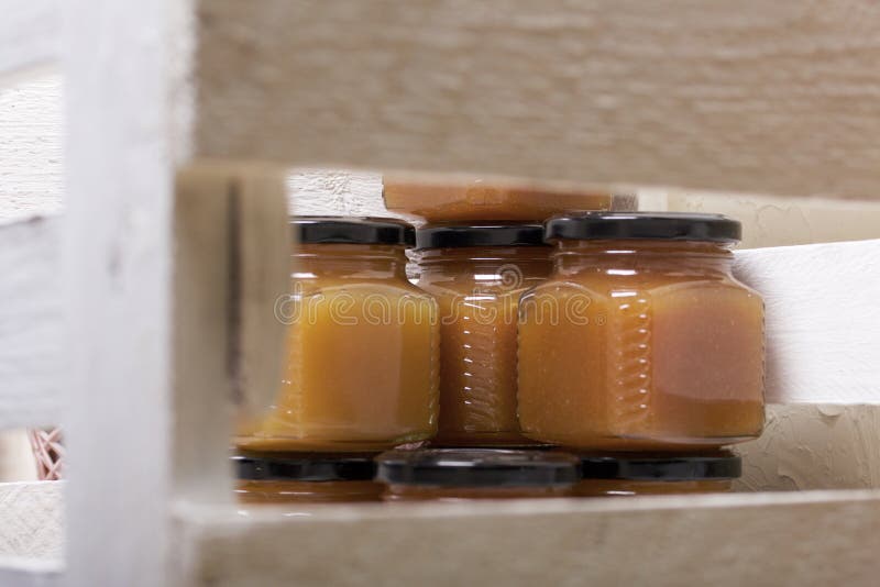 Fruit Jam in Jars. Stands in a Wooden Box Painted White Stock Photo