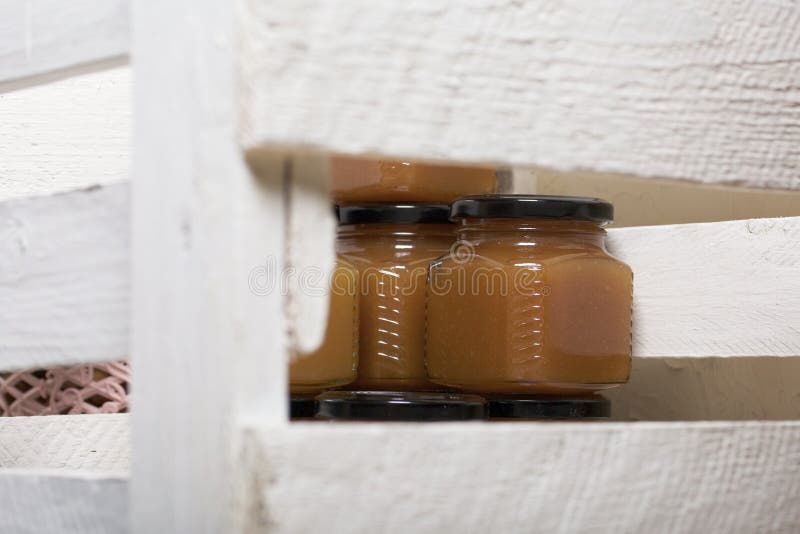 Fruit Jam in Jars. Stands in a Wooden Box Painted White Stock Image