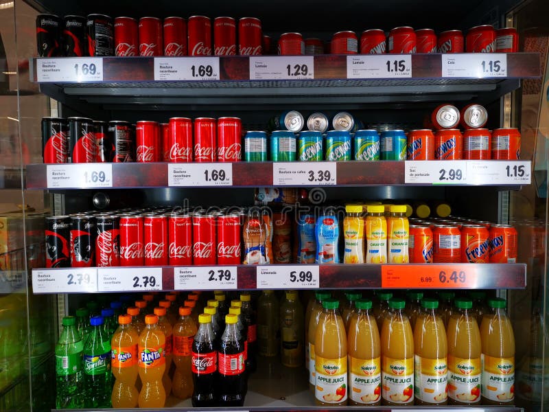 Fruit juices and carbonated in the showcase in a supermarket.