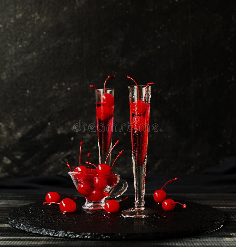 Fruit Liqueur or Apirol with Cherries Cocktail on Black Background