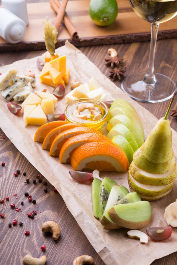 Fruit Platter Full of Snacks for White Wine Served on a Wooden Table
