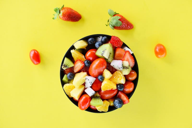 Fruit salad bowl fresh summer fruits and vegetables healthy organic food strawberries orange kiwi blueberries dragon fruit