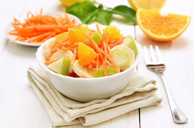 Fruit salad with in bowl on white wooden table