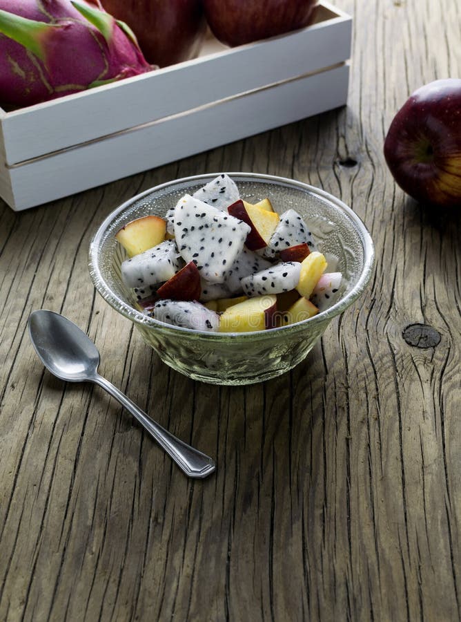 Fruit salad in a bowl on the wooden table. royalty free stock image