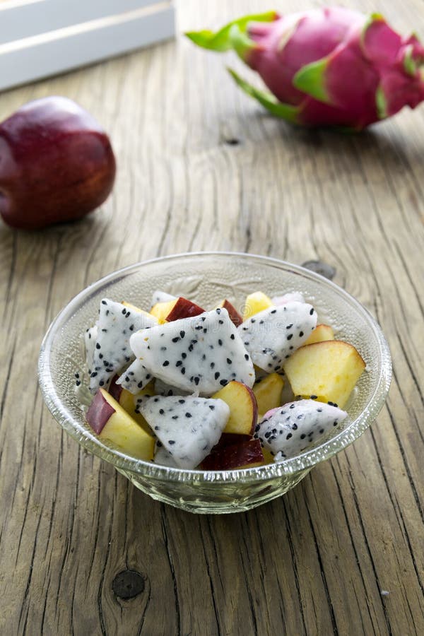 Fruit salad in a bowl on the wooden table. Selective focus. stock photos