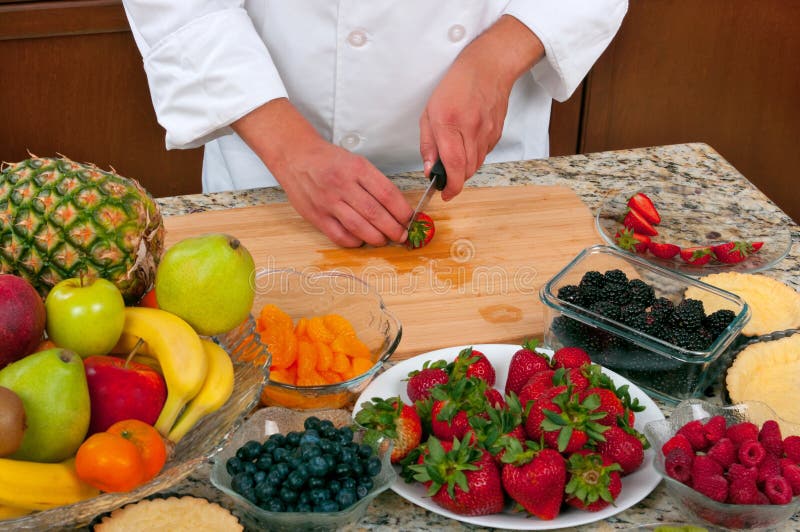 Chef making delicious fruit tarts