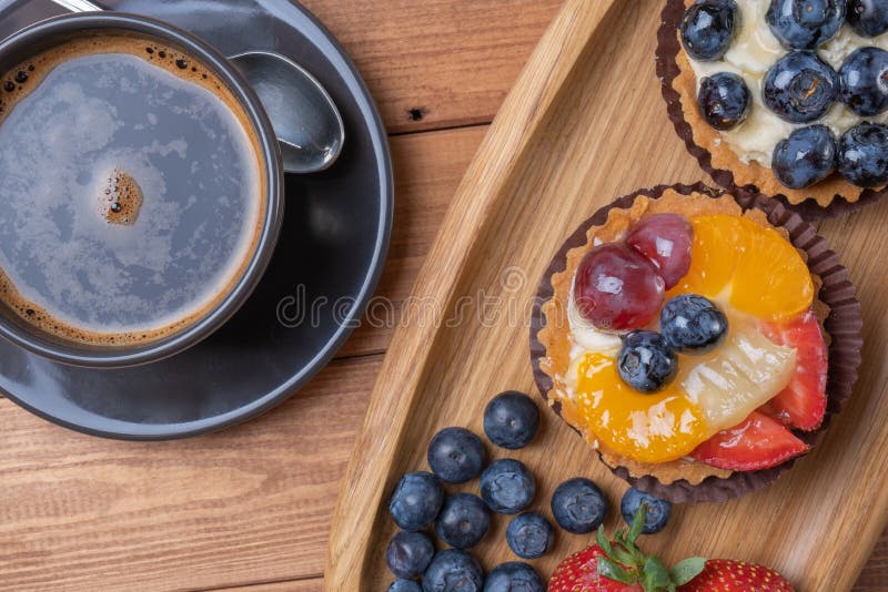 Fruit Tartlets on a Wooden Plate and Cup of Coffee on the Table, Fruit