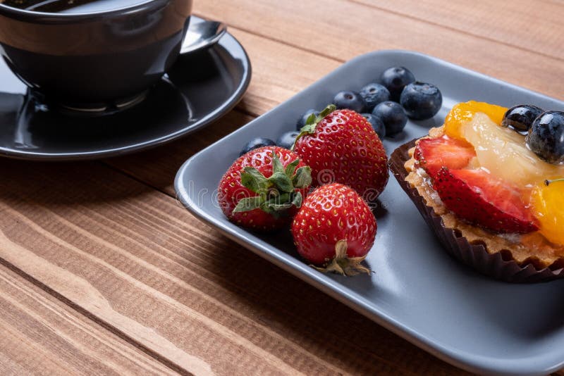 Fruit Tartlets on a Wooden Plate and Cup of Coffee on the Table, Fruit