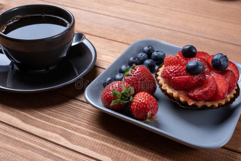 Fruit Tartlets on a Wooden Plate and Cup of Coffee on the Table, Fruit