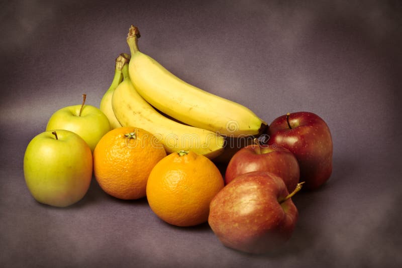 Still life of colorful oranges, apples and banana on vintage background. Still life of colorful oranges, apples and banana on vintage background