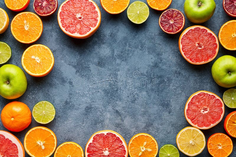 Fruits sliced mix frame flat lay on blue concrete background blank copy design space royalty free stock photo