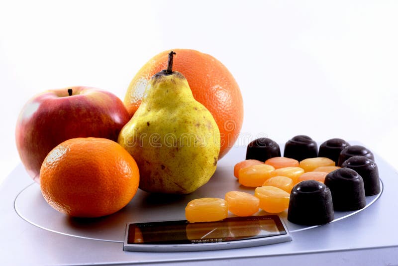 Fruits vs sweets on scale stock photo. Image of candies 38627160