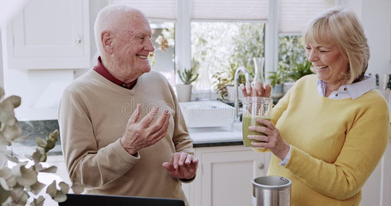 Frukostsmoothie och ett gammalt par i köket gör bra mat och detox-diet hemma. Näring och arkivfilmer