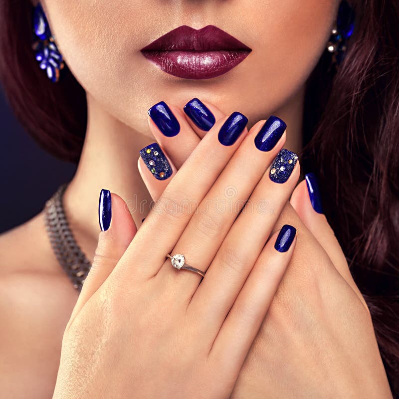 Frumoasă femeie cu machiaj perfect și manichiură albastră, cu bijuterii stock image