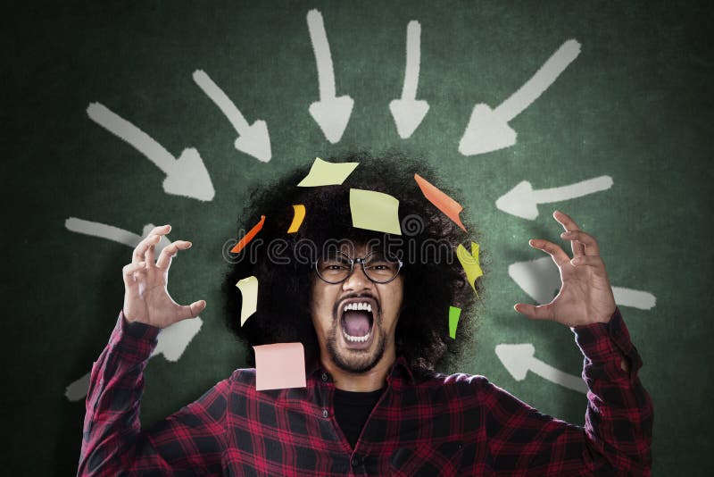 Frustrated Afro man under arrows over his head