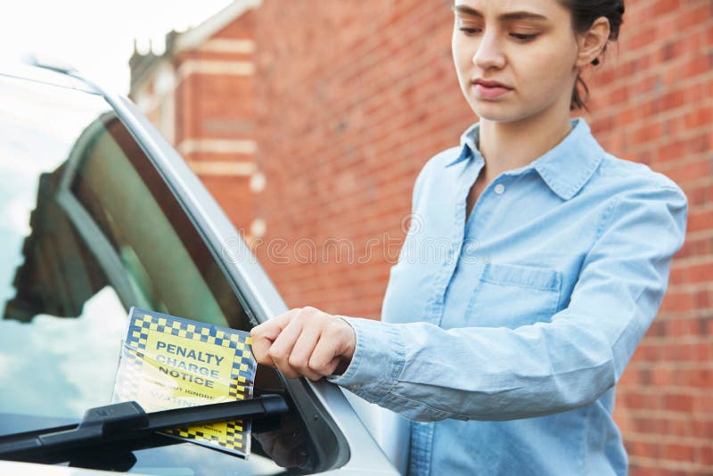 Frustrated Female Motorist Looking At Parking Ticket stock images Frustrated Female Motorist Looking At Parking Ticket stock images