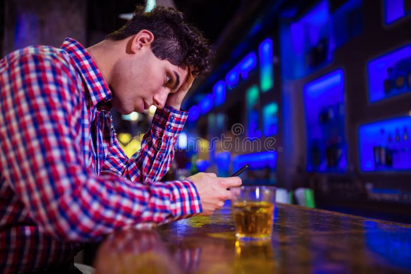 Frustrated man at bar counter royalty free stock photo